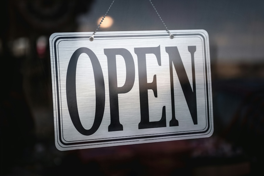 A black and white sign displaying the word 'OPEN'.